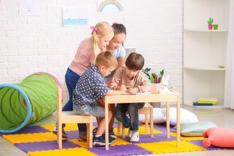 4 Kinder beim Zeichen auf einem Tisch 